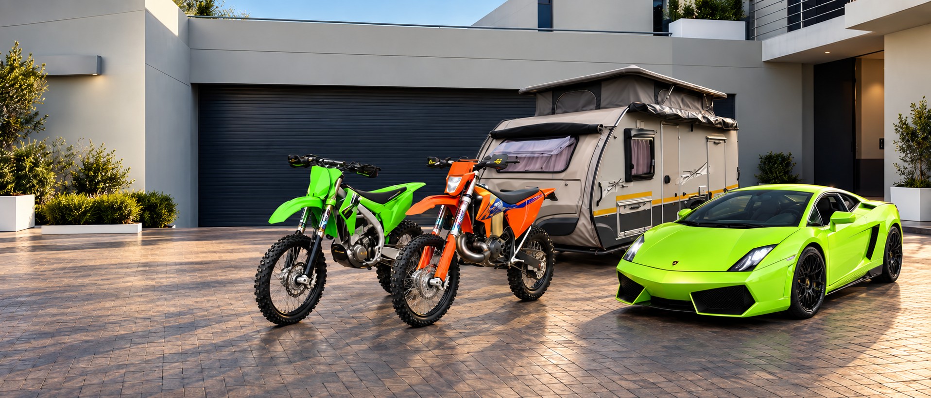 Two off-road motorcycles, a camper and a green sports car outside the Bropac showroom